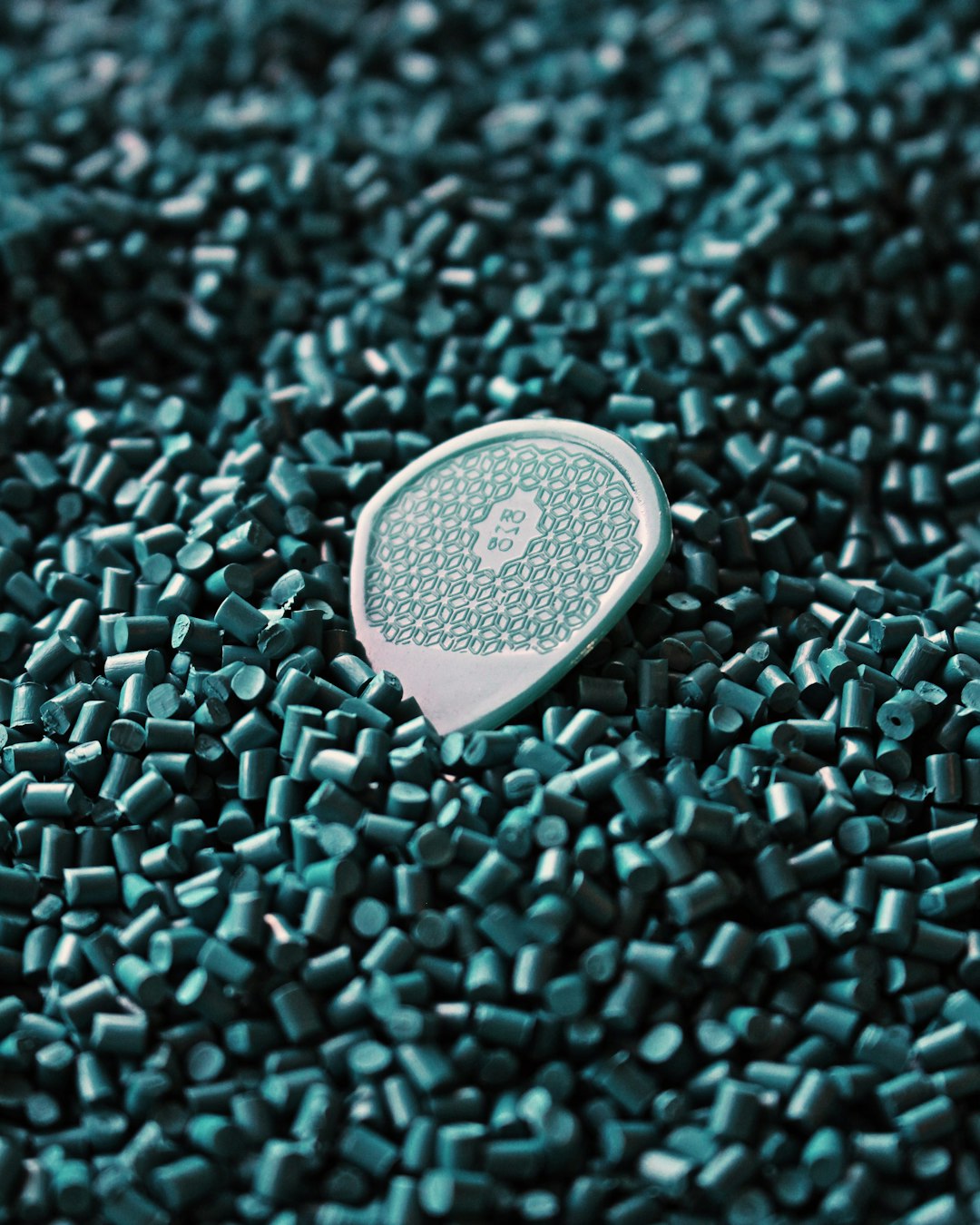 a-close-up-of-a-tennis-racket-laying-on-a-pile-of-green-tiles-hx1cjhl-7-k